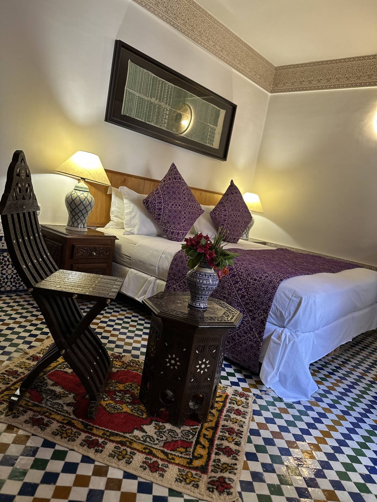 Comfort triple room with Moroccan bedding and carved furniture at Riad Mazar Fes